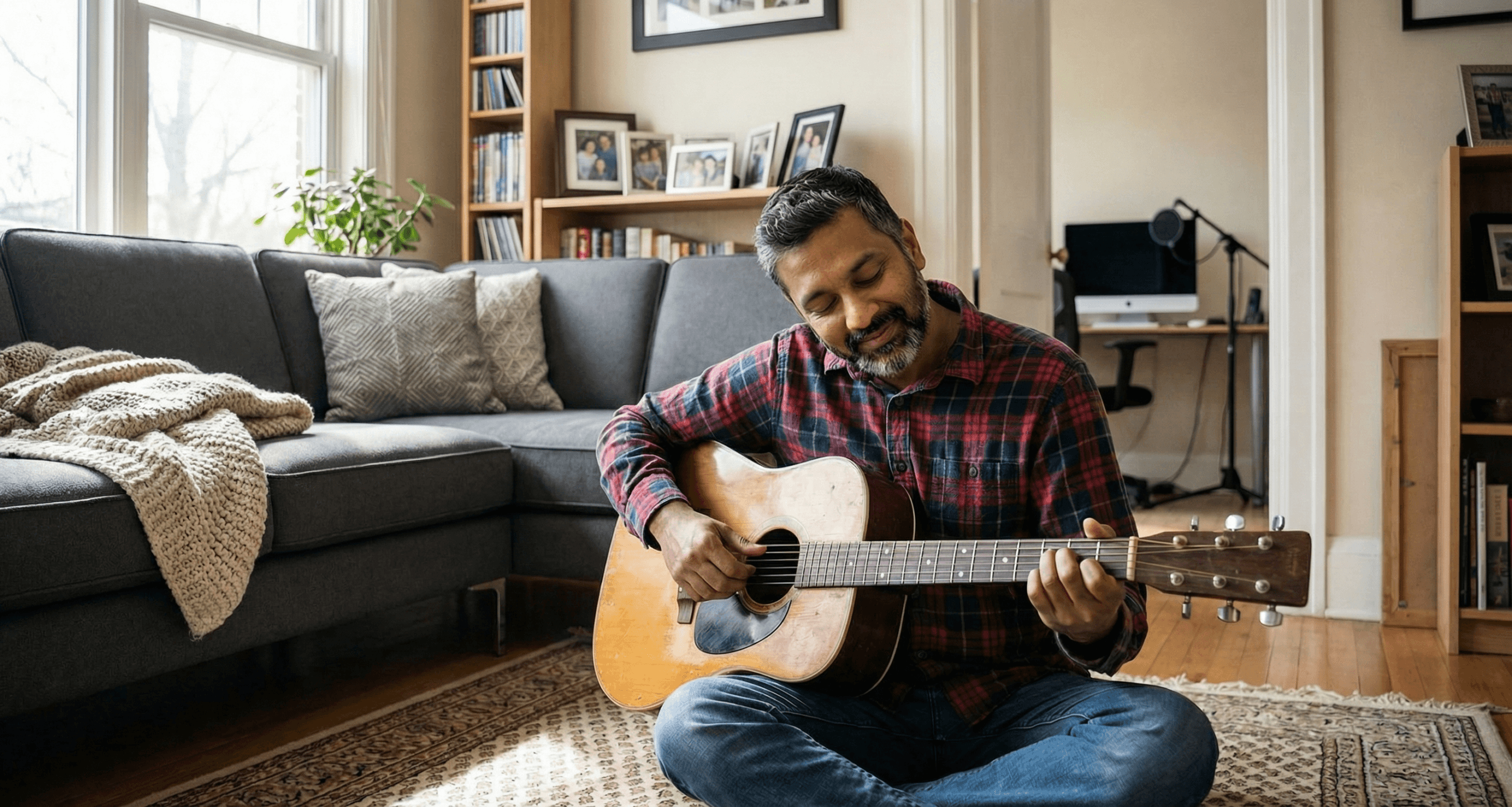 South Asian man playing guitar with no recording equipment showing protected private interests essential for creator burnout prevention