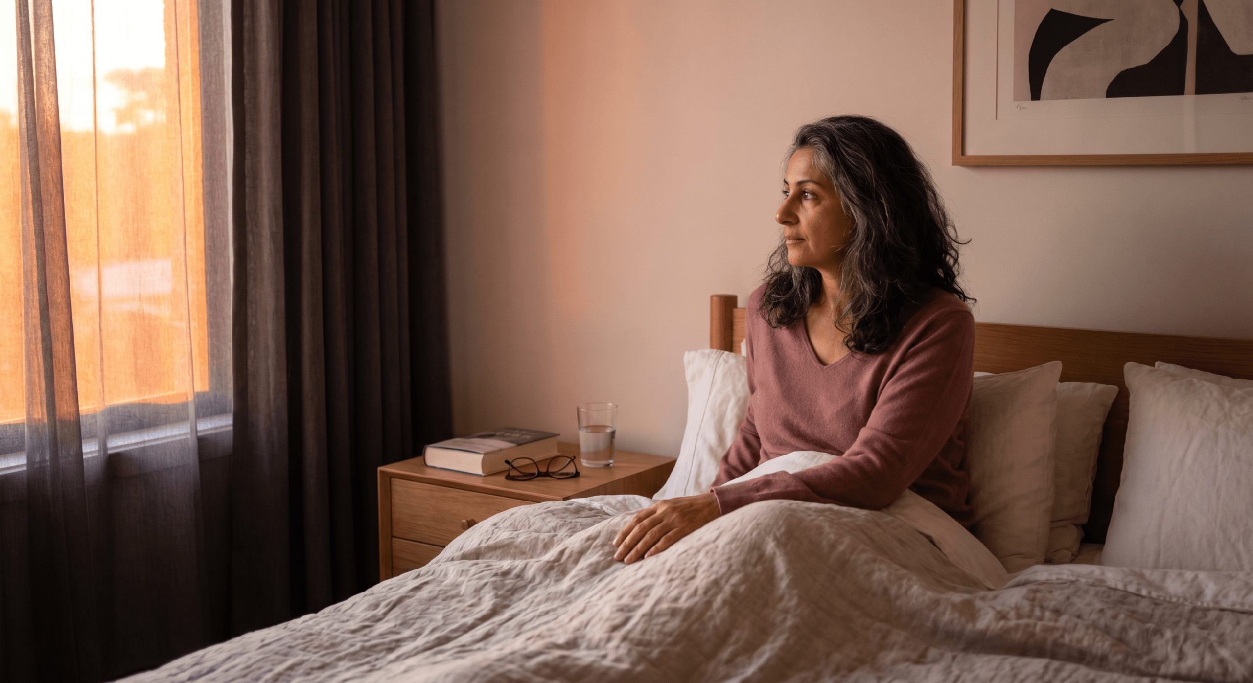 Middle Eastern woman waking peacefully at dawn illustrating circadian rhythm influence on NAD+ and cellular energy metabolism